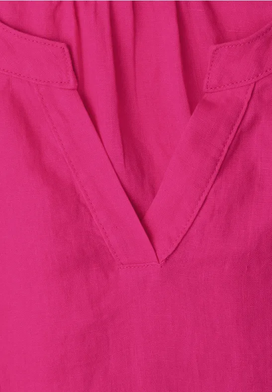 Magenta stof met V-hals en subtiele naden.