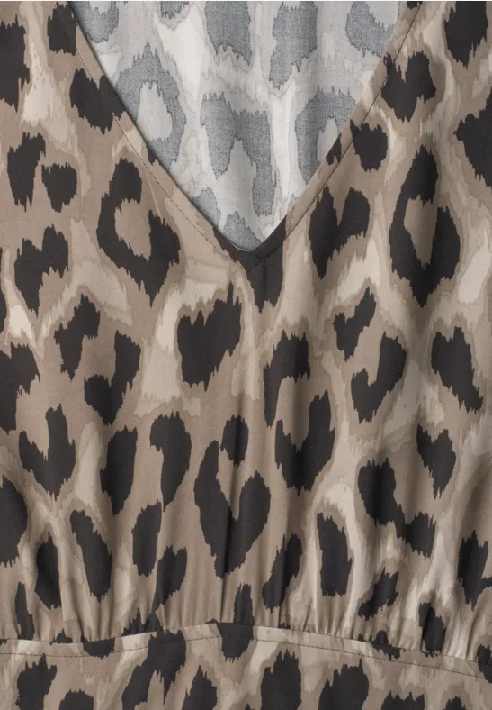 Close-up van een top met bruin-beige-zwart luipaardprint en V-hals.