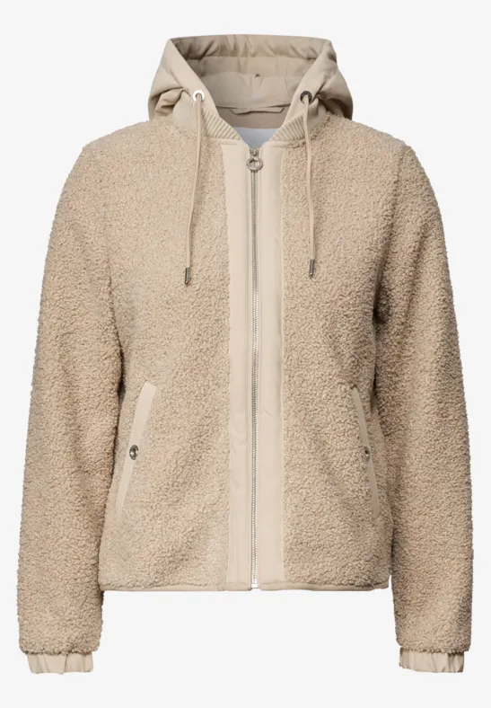 Beige teddyfleece-jas met capuchon, rits en steekzakken.