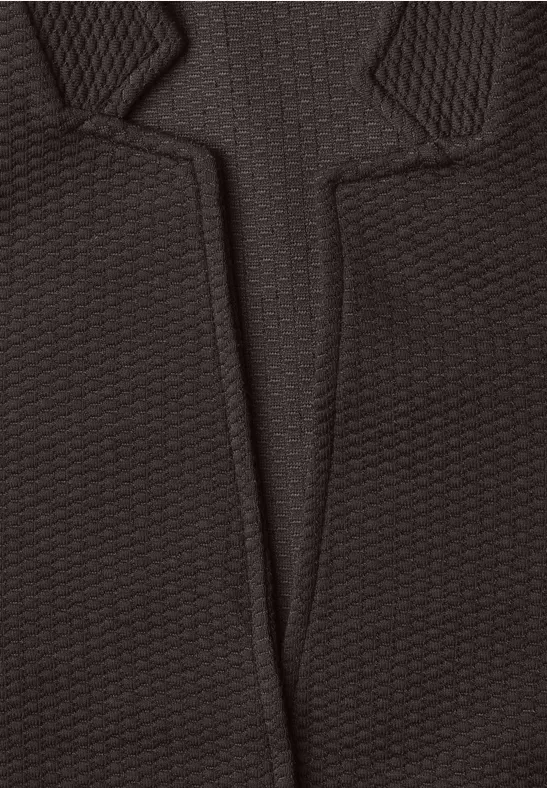 Tissu noir structuré avec crantage en V et motif en relief.