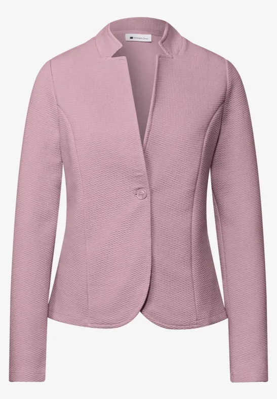 Veste blazer rose clair pour femme, manches longues et fermeture par bouton.
