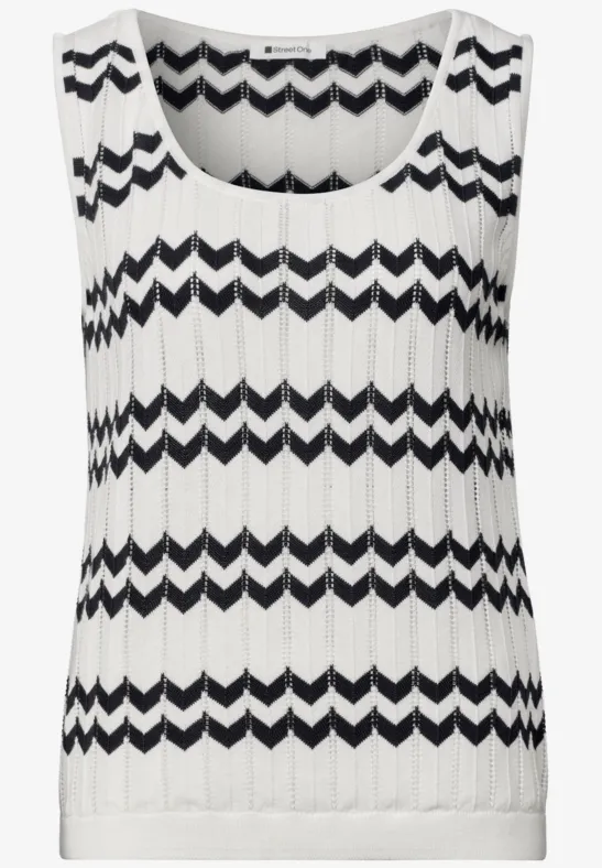Haut sans manches en maille blanche à rayures zigzag noires, côtelé et coupe décontractée.