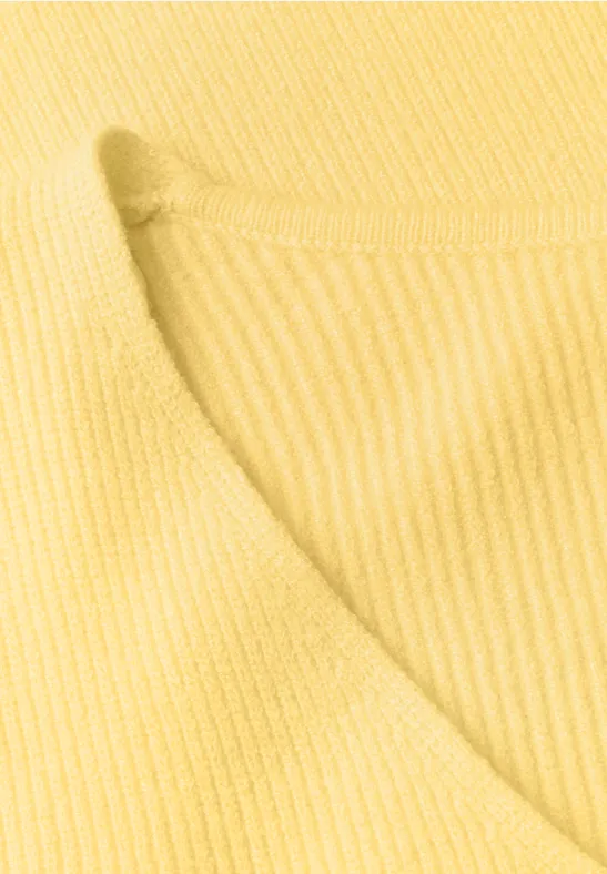 Close-up van gele, geribbelde tricot met ronde hals