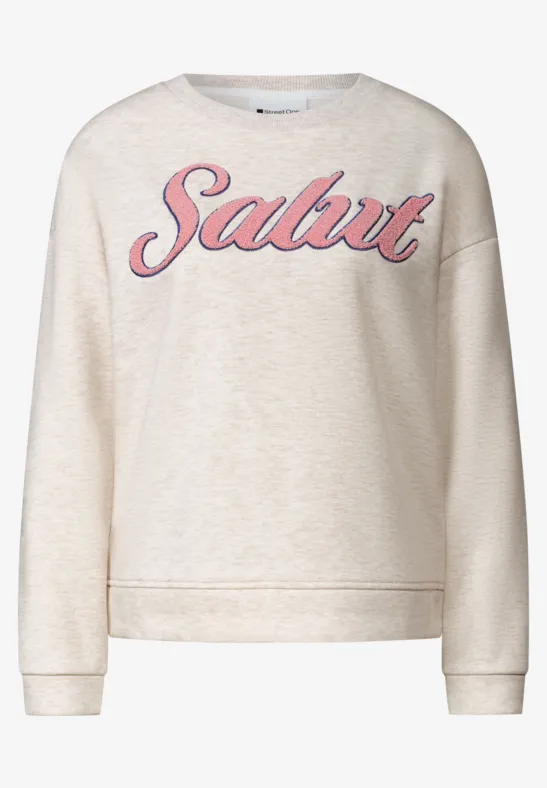 Pull beige avec l'inscription 'Salut' en rose