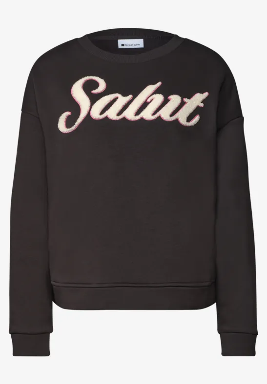 Pull noir décontracté avec l'inscription 'Salut' en lettres blanches et rouges sur le devant.
