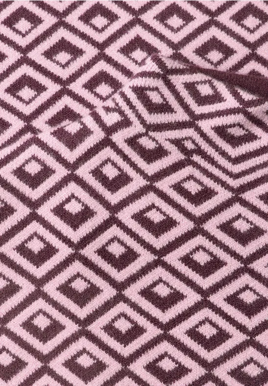 rosa Stoff mit schwarzen Rauten in geometrischem Muster