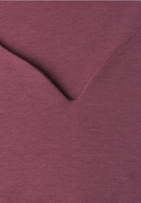 Gros plan d’un haut bordeaux à col en V avec texture fine.