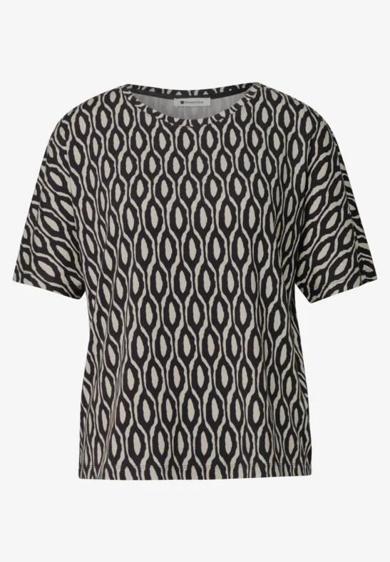 Zwart kort shirt met beige, golvend grafisch patroon.