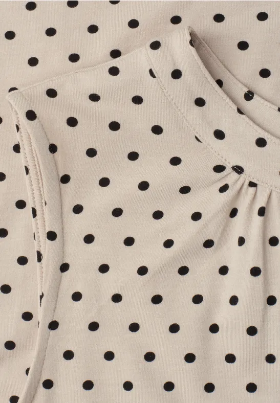 Tissu beige à pois noirs