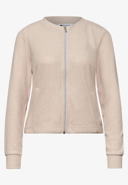 Cardigan beige à fermeture éclair intégrale et encolure ronde.