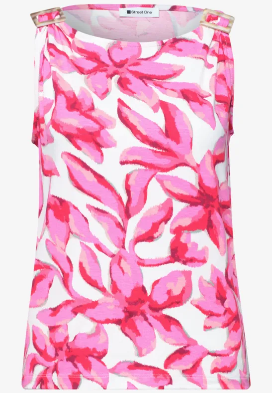 Mouwloos topje wit met groot roze bloemmotief.