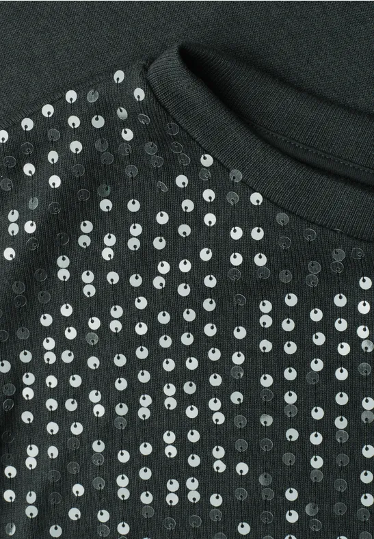 Close-up van zwarte stof met glanzende zilverkleurige pailletten