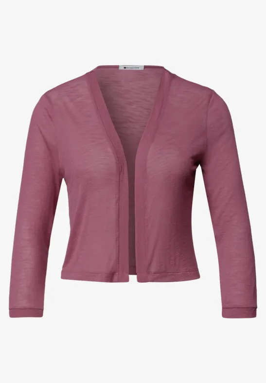 Een kort, roze gebreid bolero met driekwartsmouwen, licht en open vooraan.
