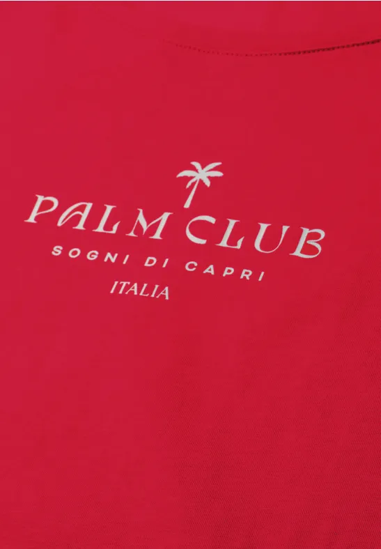 Rood T-shirt met wit „Palm Club“-logo, palmboom-icoon en tekst „Sogni di Capri Italia“.
