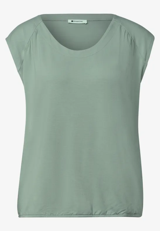 Haut sans manches femme en vert pastel avec encolure ronde et coupe décontractée.
