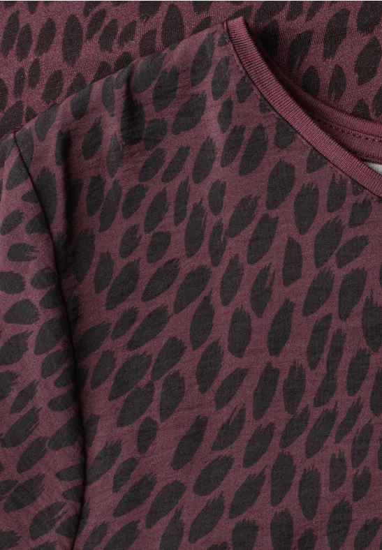 Pull bordeaux à manches longues avec motif ovale noir et encolure ronde