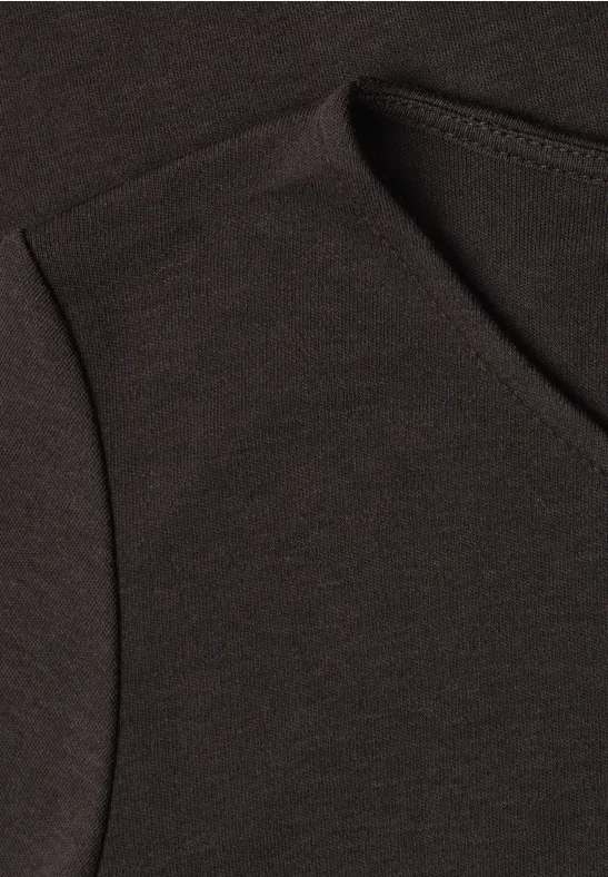 Nahaufnahme eines dunklen T-Shirts mit sichtbarer Naht am Ausschnitt und an der Schulter.