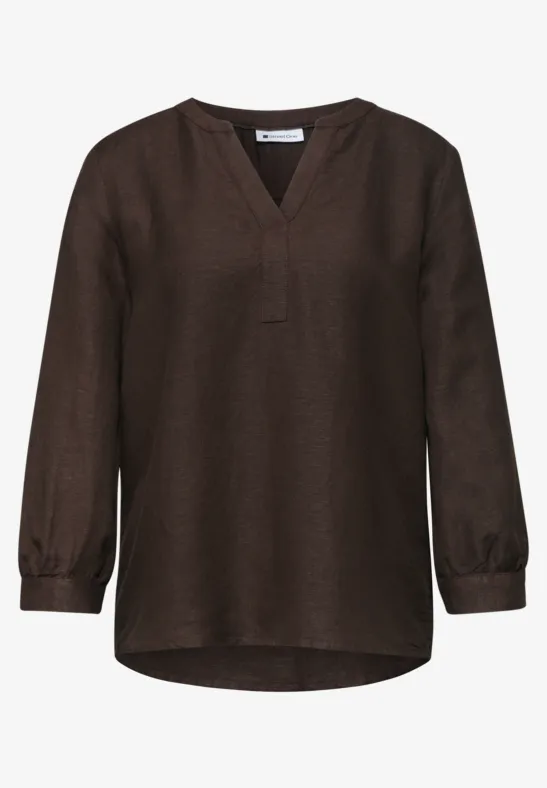 Donkerbruine, losse blouse met lange mouwen en V-hals.