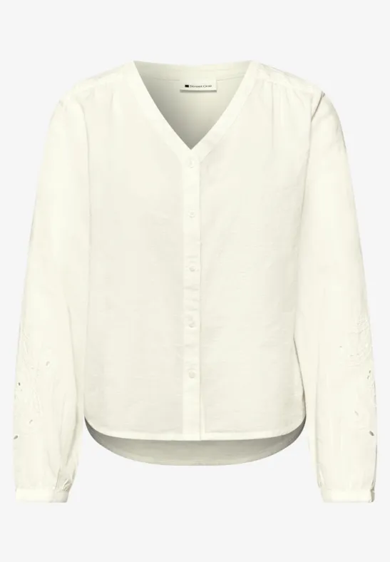 Blouse met V-hals en borduursel off white