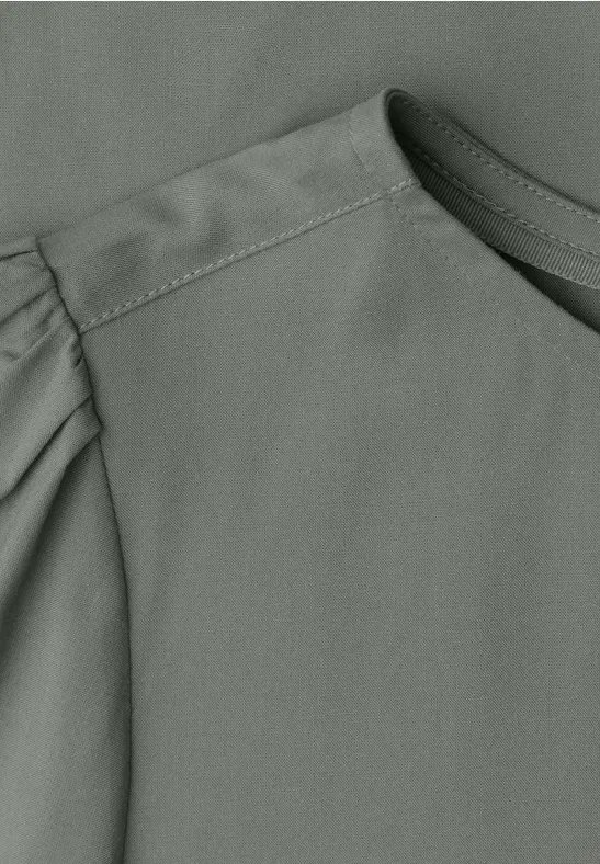 Grijs bovenstuk met ronde hals en subtiele plooien aan de mouw.