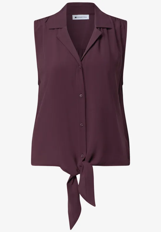 Mouwloze pruimkleurige blouse met knopen en voorstrikdetail.
