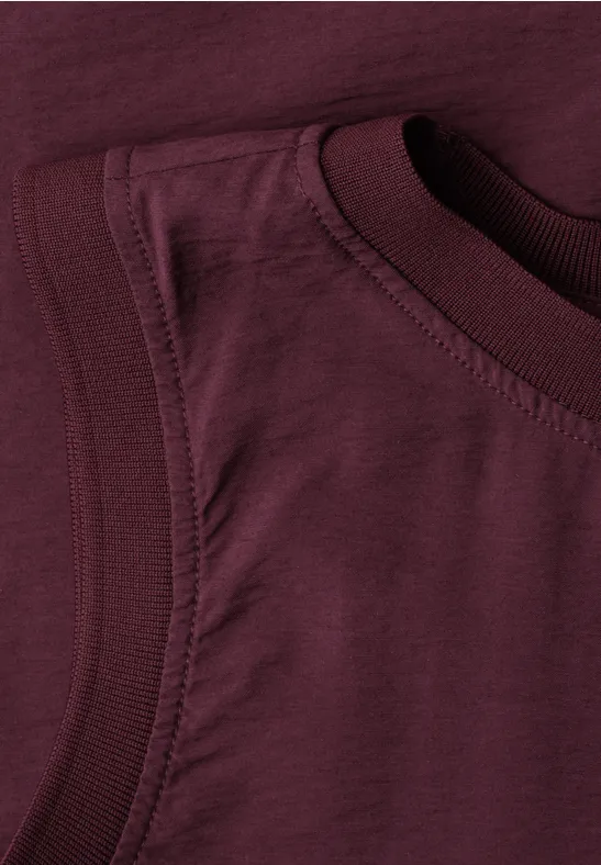 Detailaufnahme eines burgunderroten ärmellosen T-Shirts aus weichem Baumwollstoff