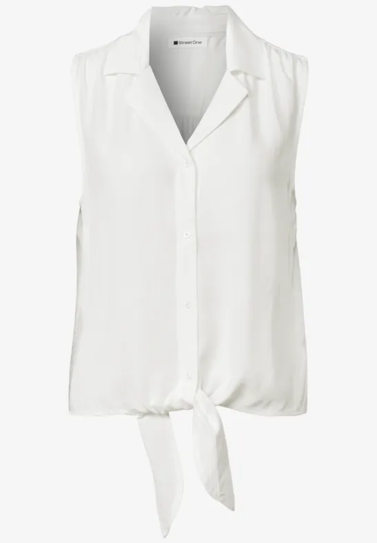 Blouse blanche sans manches avec col en V et nœud avant