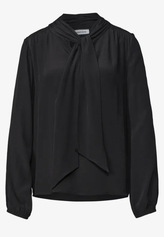 Blouse noire à manches longues avec col à nouer élégant.