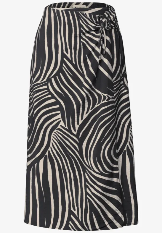 Jupe mi-longue à motif zèbre abstrait noir et blanc avec un nœud latéral à la taille