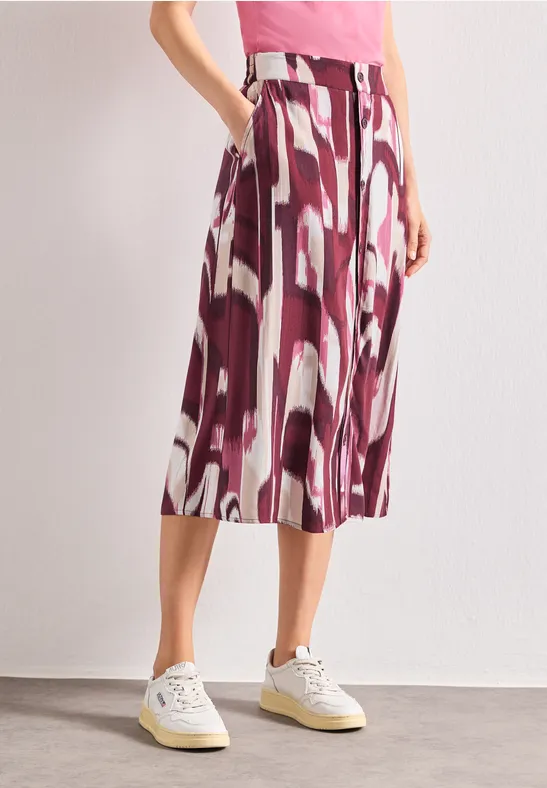 Dames midirok met abstracte bordeaux-witte print, gecombineerd met witte sneakers