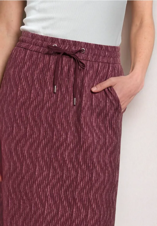Jupe bordeaux mi-longue avec taille élastique, cordon et poches latérales