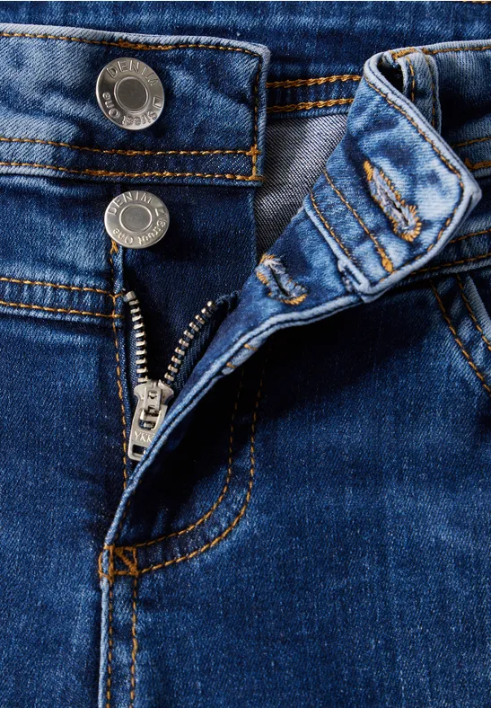 Nahaufnahme einer offenen blauen Jeans mit sichtbarem Reißverschluss.