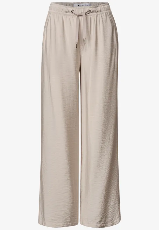 Beige wijde broek van licht, gestructureerd materiaal met elastische taille en koordsluiting