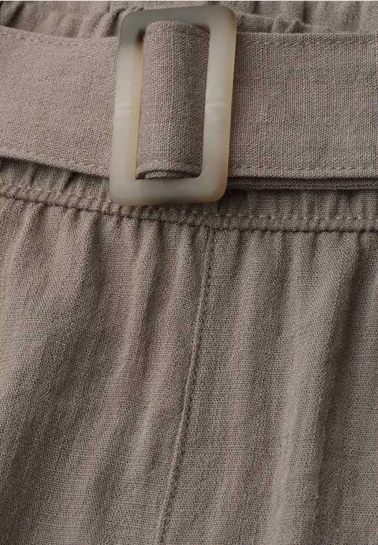 Close-up van beige stofriem met rechthoekige gesp, licht gegolfd, gemaakt van een linnen- of katoenmengsel.
