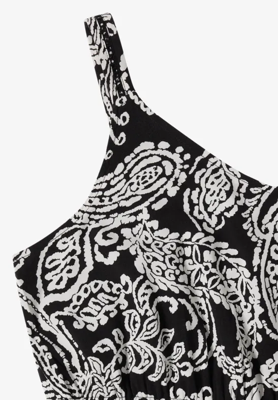 Top noir asymétrique orné d'un motif cachemire blanc.