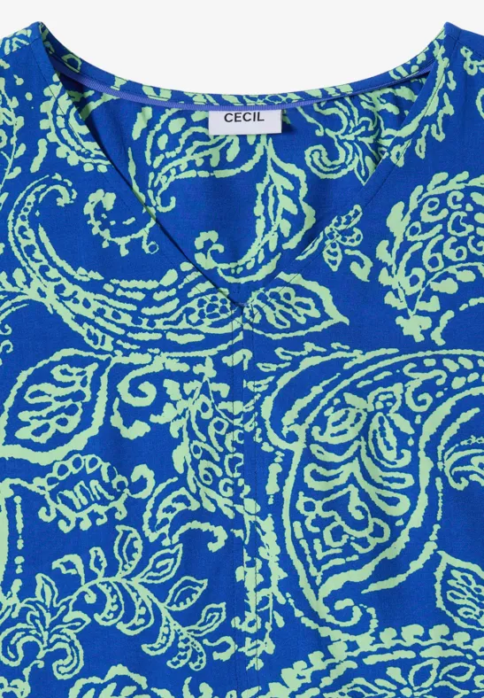Mouwloos topje in felblauw met lichtgroen paisleypatroon en CECIL-label.