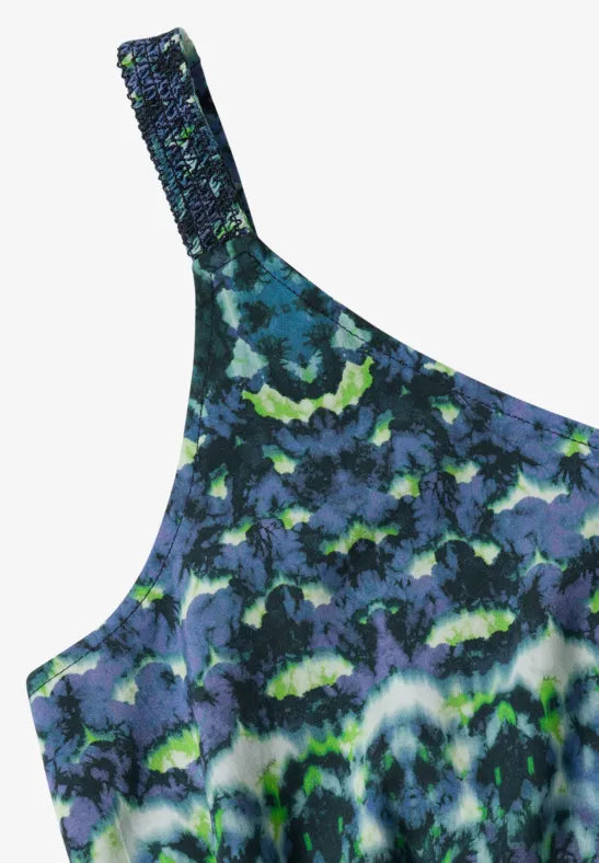 Top asymétrique à motif tie-dye bleu, vert et noir.