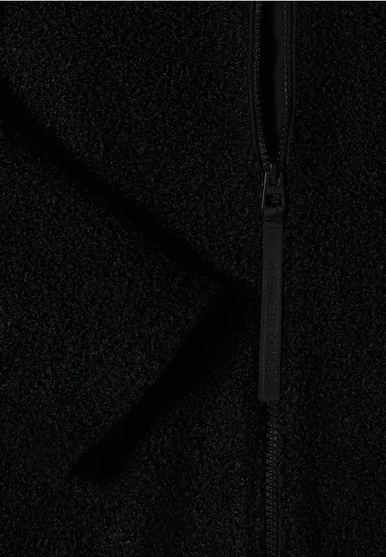 Nahaufnahme eines schwarzen Fleece-Stoffes mit Reißverschluss