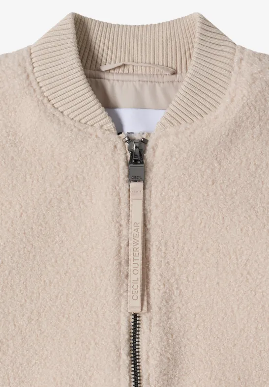 Beige Teddy-Fleece-Jacke mit Reißverschluss und geripptem Stehkragen.