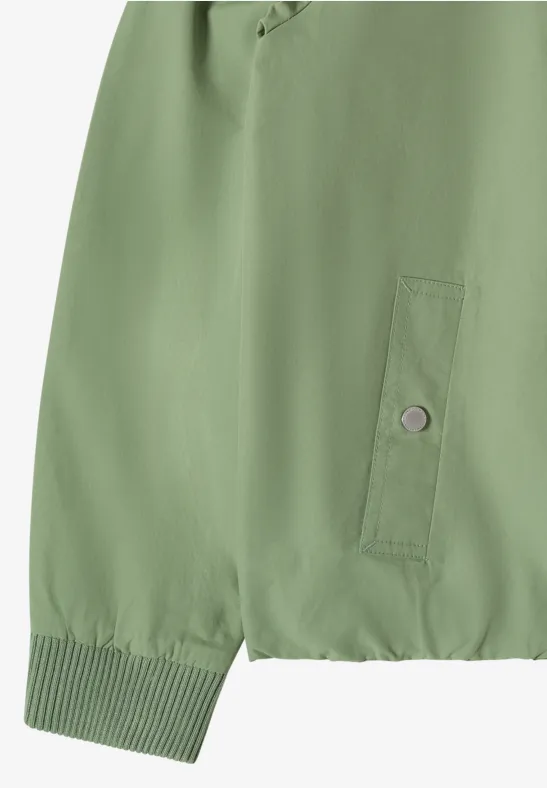 Veste verte à poignets côtelés, petite poche latérale boutonnée et ourlet élastique