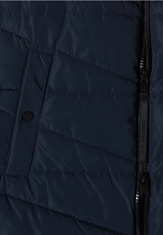 Veste matelassée bleu foncé avec fermeture éclair et poche à rabat bouton.