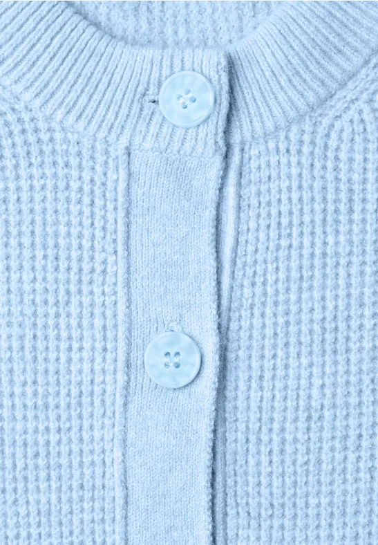 Hellblauer Strickcardigan mit Rippenmuster und zwei Knöpfen.