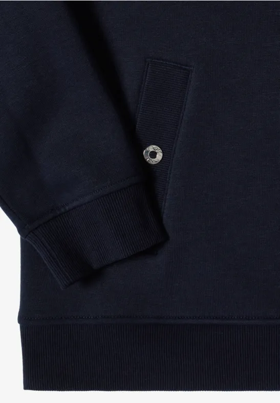 Nahaufnahme eines dunkelblauen Sweatshirts mit geripptem Ärmelbündchen, Eingrifftasche und silbernem Druckknopf.