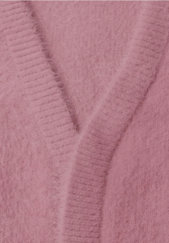Nahaufnahme eines rosa, flauschigen Strickcardigans mit V-Ausschnitt.