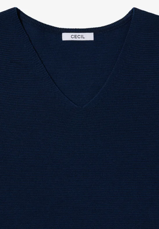 Pull bleu foncé à col V en maille fine côtes plates avec étiquette 'Cecil' à l'arrière.