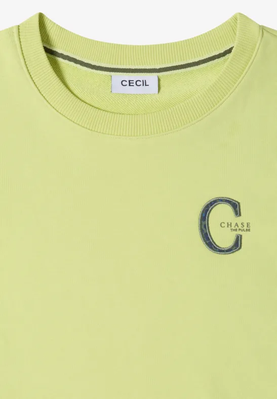 Hellgrünes T-Shirt mit Rundhalsausschnitt, Markenlabel 'CECIL' am Kragen und besticktem 'C Class'-Logo auf der Brust.