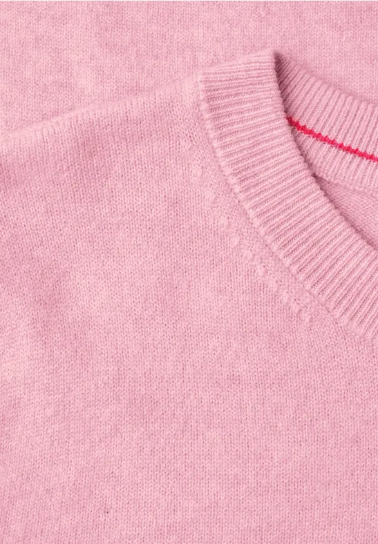 Ein rosafarbener Pullover aus weichem Feinstrick.