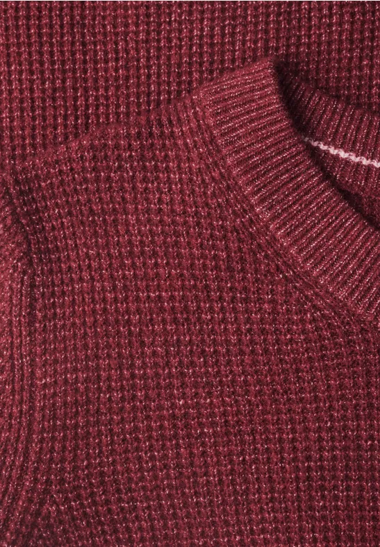 Nahaufnahme eines rot-melierten Strickpullovers