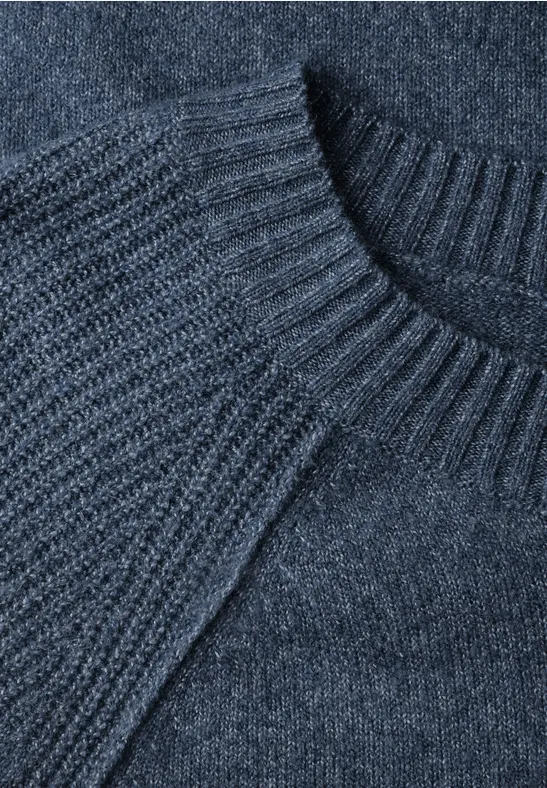 Nahaufnahme eines dunkelgrauen Strickpullovers mit Rundhalsausschnitt und Rippenstruktur.