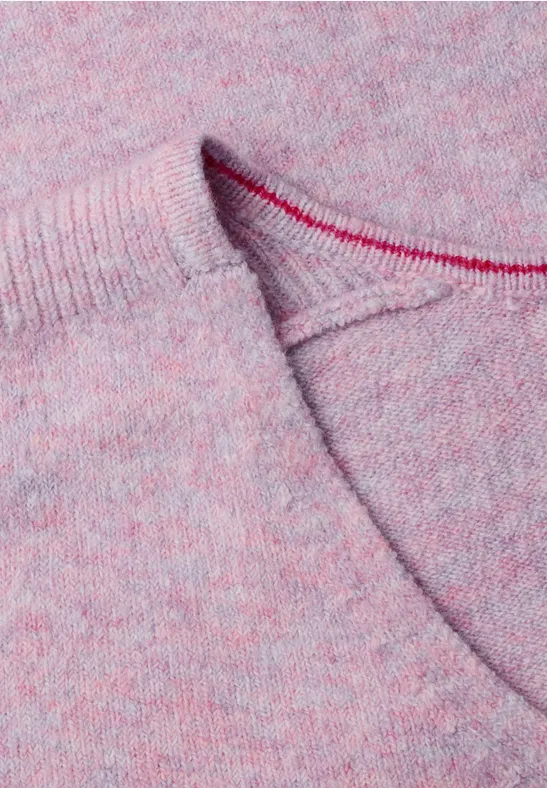 Nahaufnahme eines rosa melierten Strickpullovers mit sichtbarer Naht.